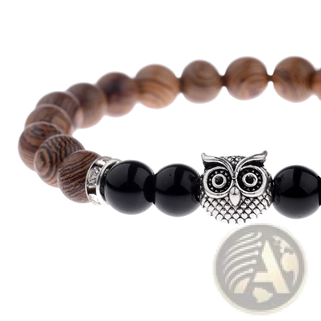 A silver owl charm bracelet featuring dark wood and black onyx beads for elegant style and symbolism