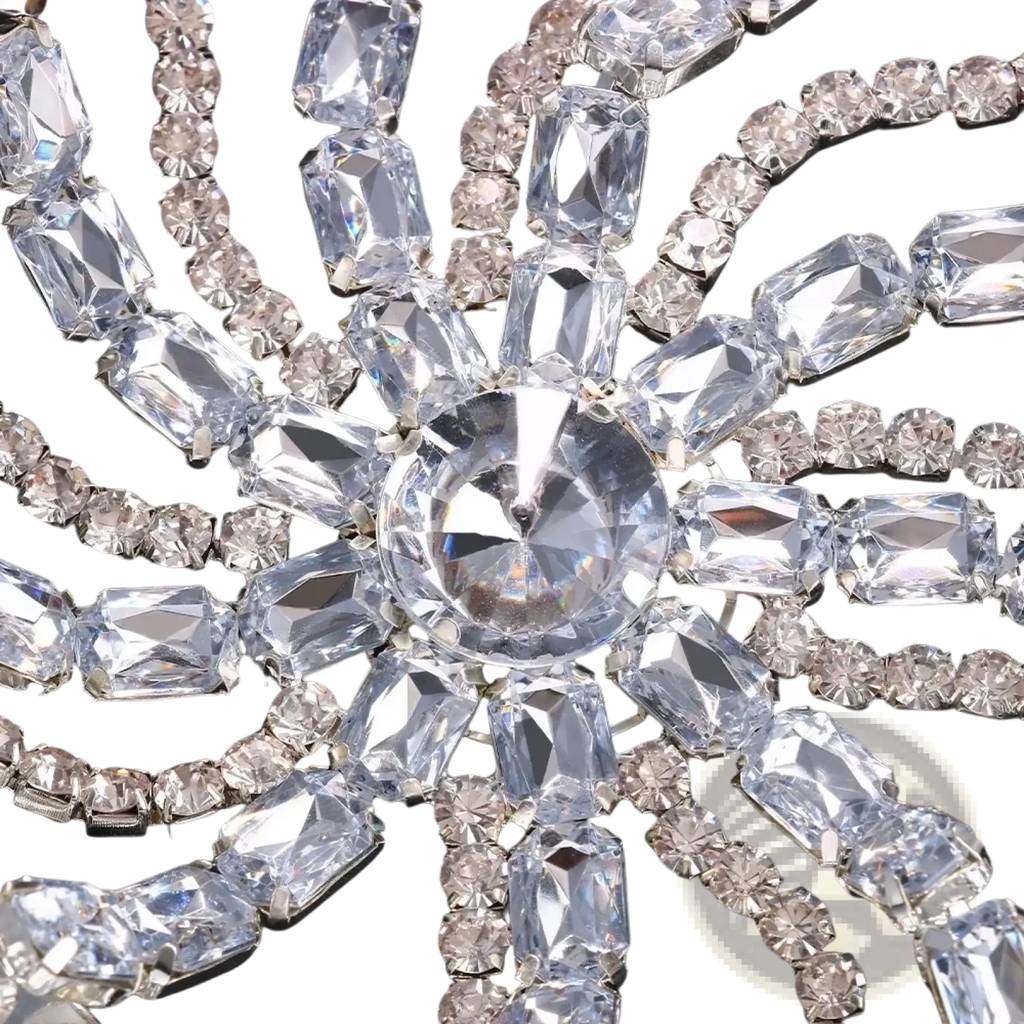 A sparkling silver crystal rhinestone bridal head chain hair jewelry with a large oval central stone and radiating accents