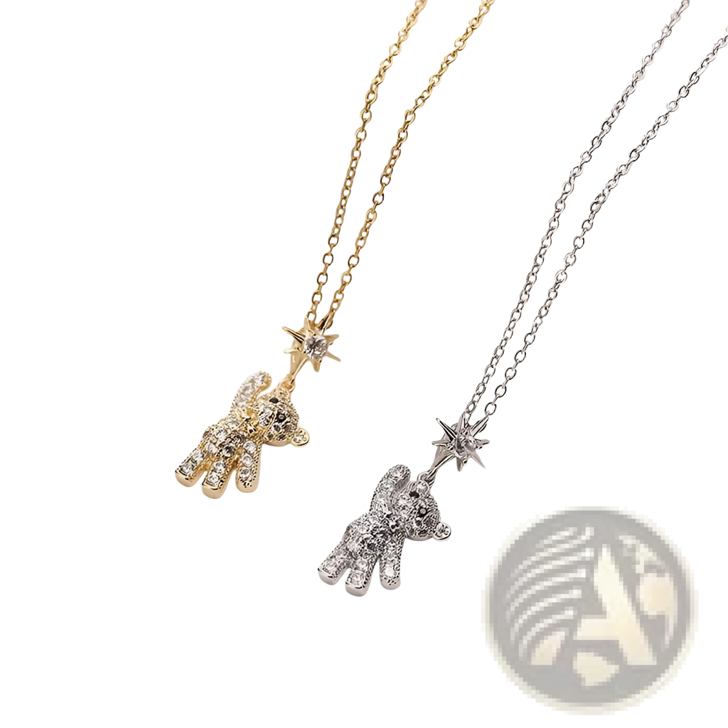 Two gold titanium steel necklaces with crystal teddy bear pendants and star-shaped charms in a delicate design