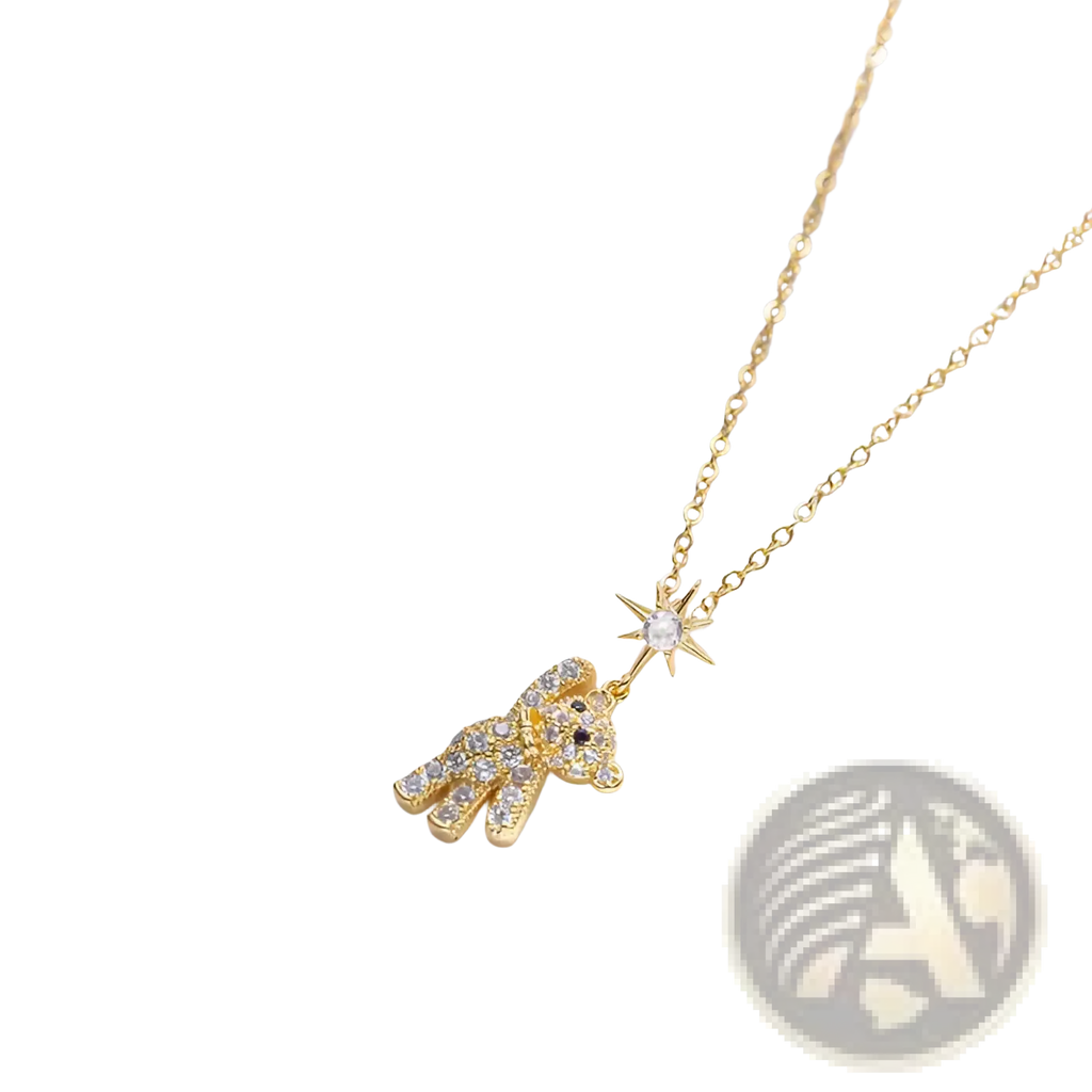 Gold-toned titanium steel necklace with a sparkling bear pendant adorned with clear crystals and a matching star charm