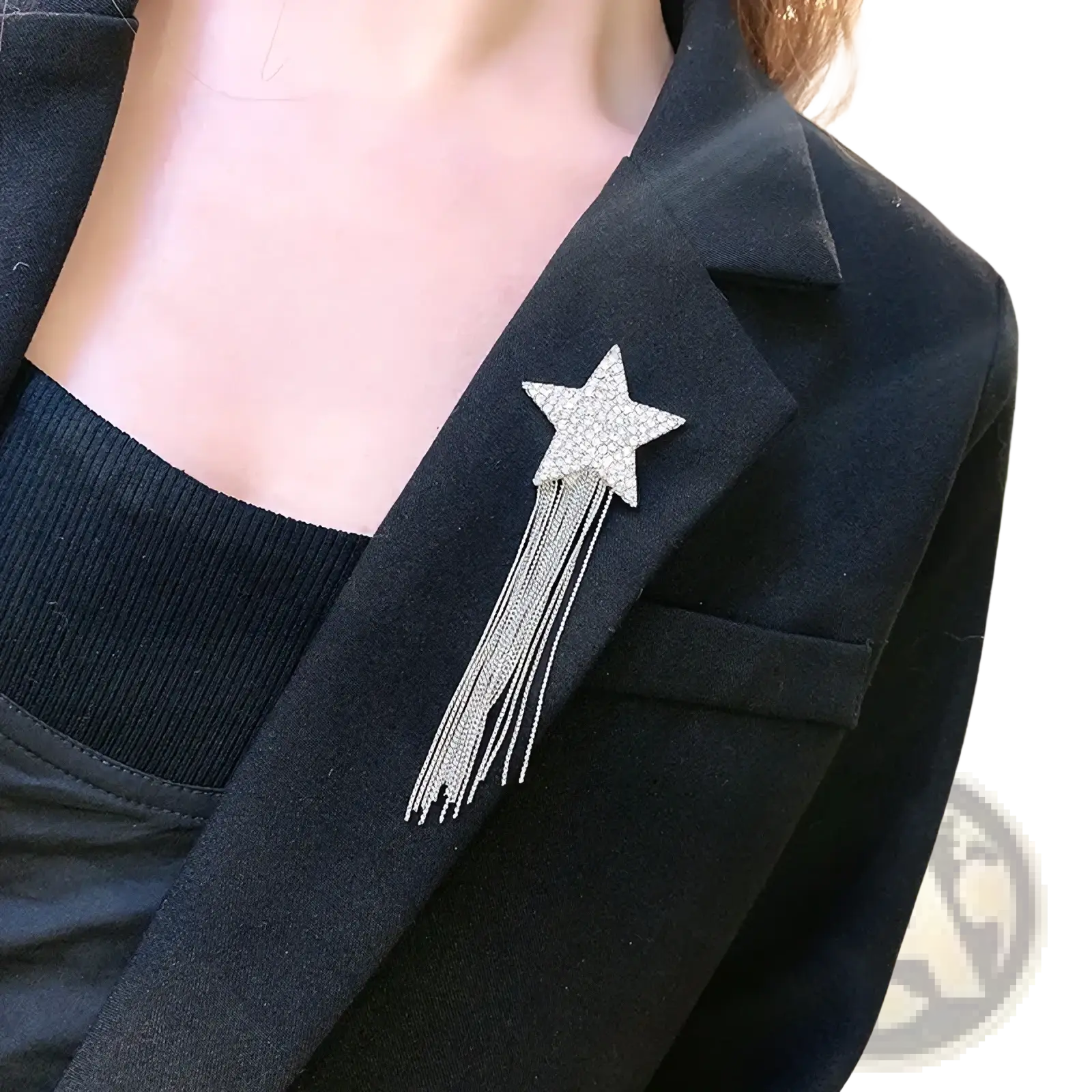 A sparkling silver star-shaped brooch with rhinestones and delicate silver chains for lapel pin use
