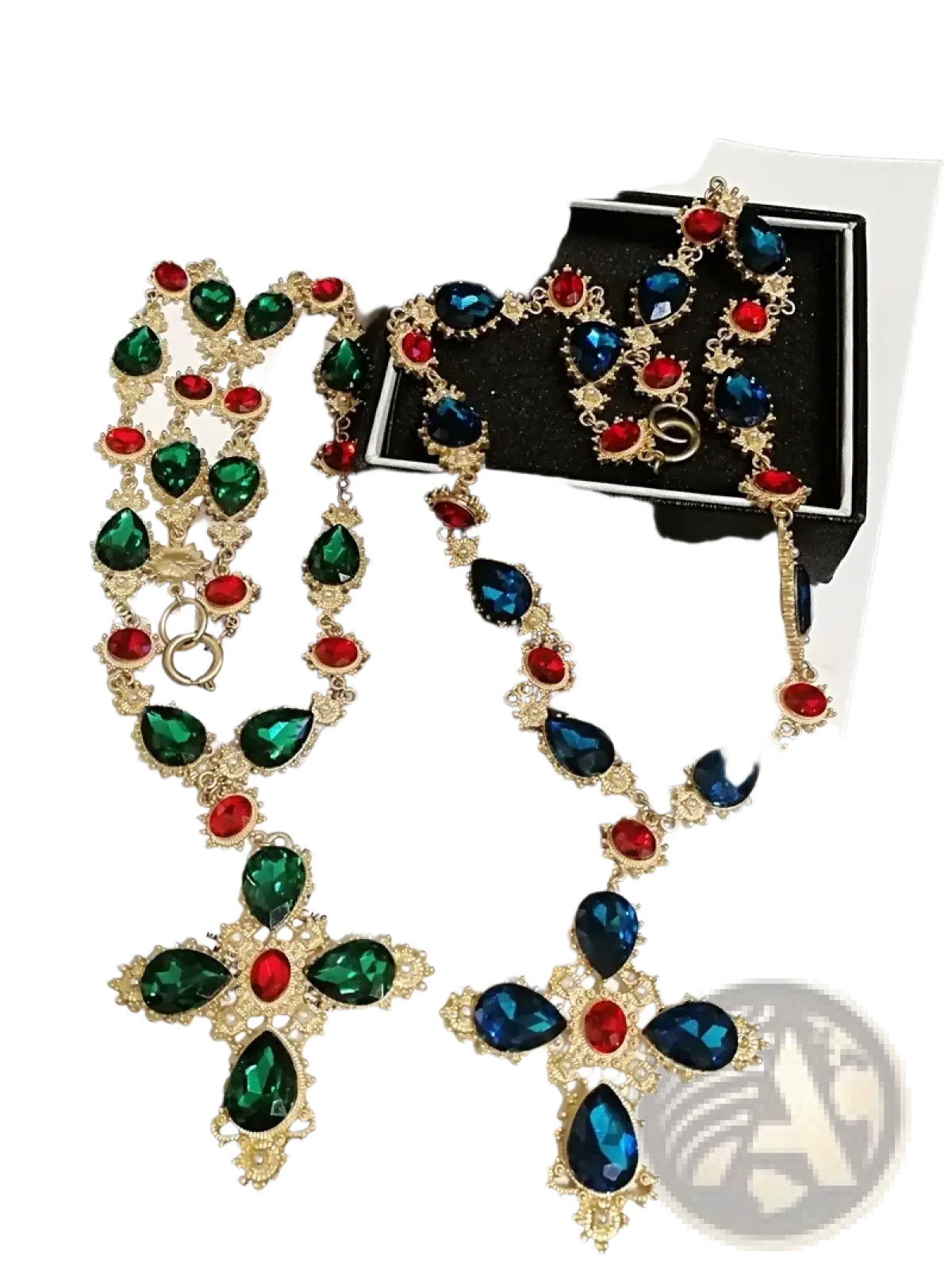 A gold-toned crystal statement choker necklace and earrings set with green, blue, and red teardrop crystals in cross design