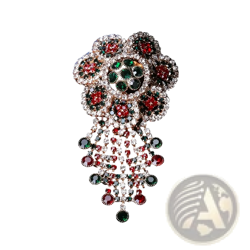 A sparkling red green and clear rhinestone floral crystal tassel brooch with a vintage palace jewelry cascade design