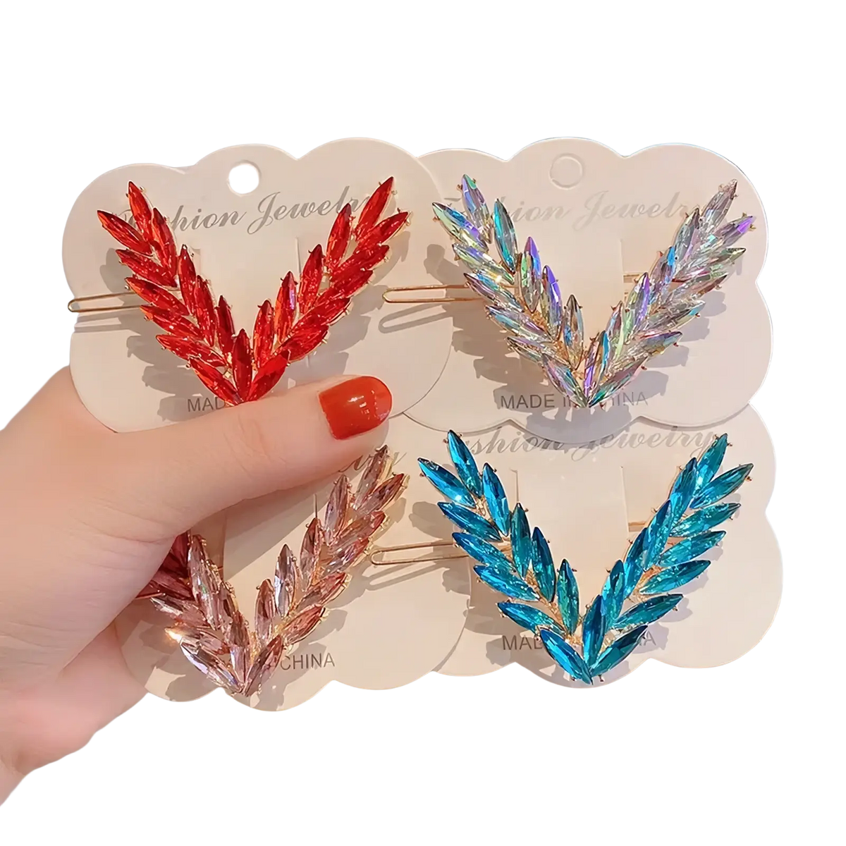 A hand holds four crystal v shape hair clips with sparkling leaf designs in red iridescent rose gold and blue hues