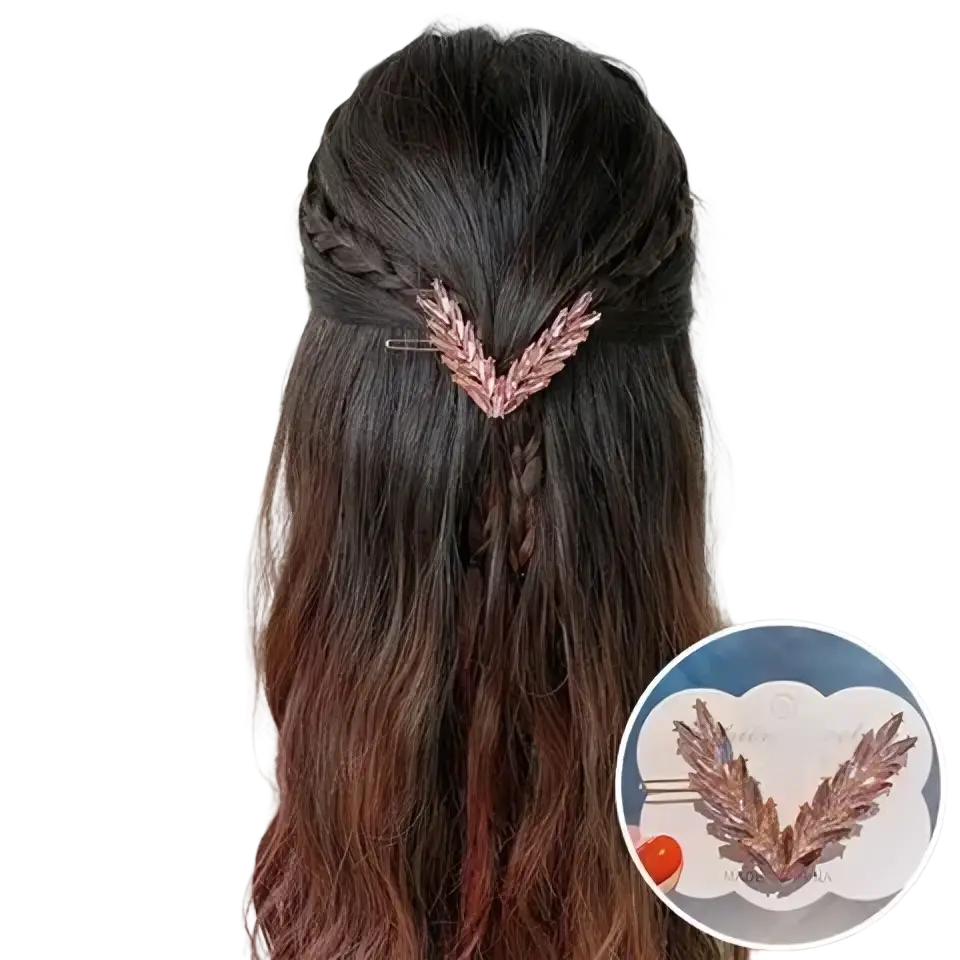 Rose gold feather-shaped crystal v shape hair clip holding a braided section of dark brown hair