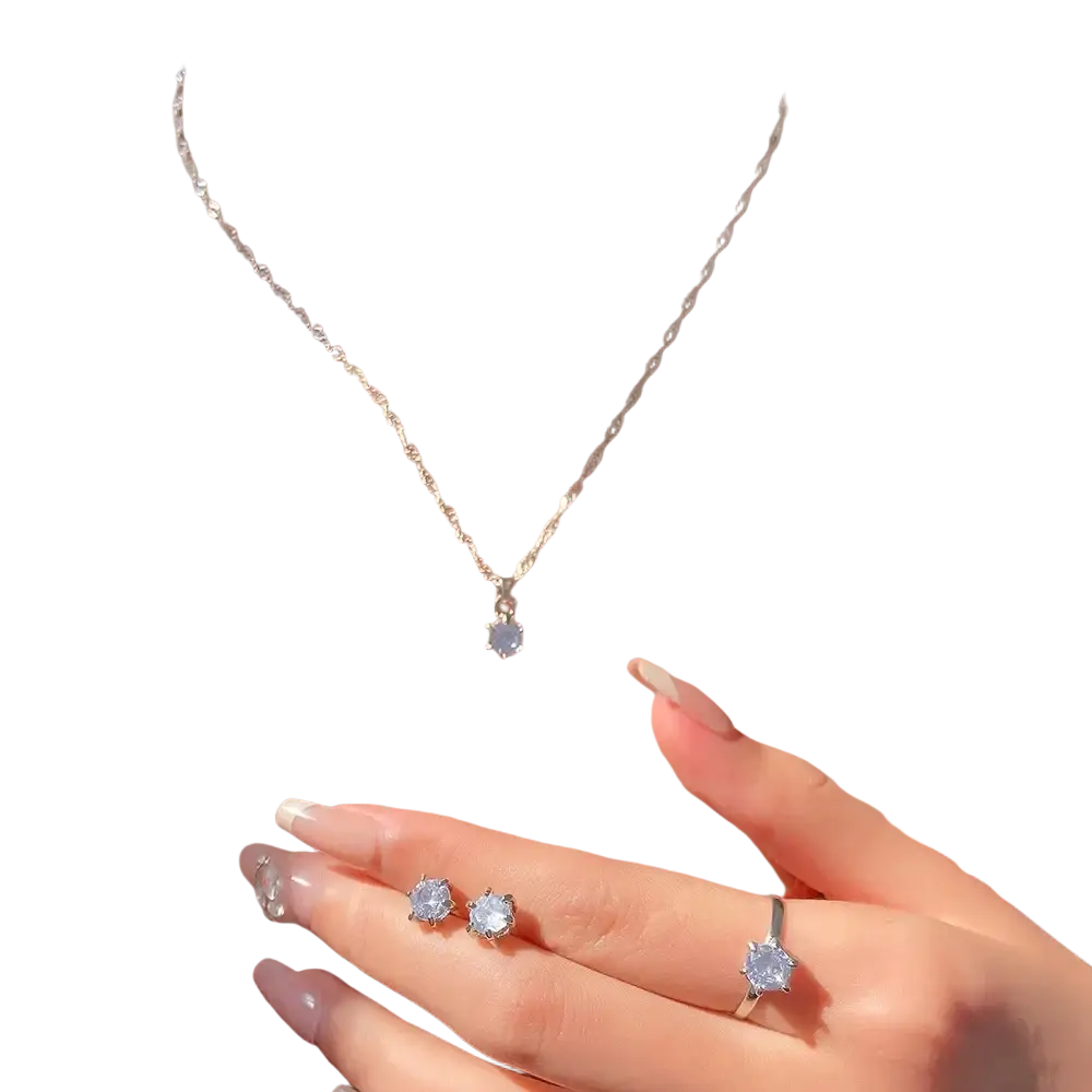 A delicate silver chain necklace with a small clear crystal zirconia pendant from a 5piece jewelry set