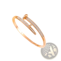 Gold-toned cubic zirconia intersecting bangle bracelet with sleek modern design and sparkling clear crystals