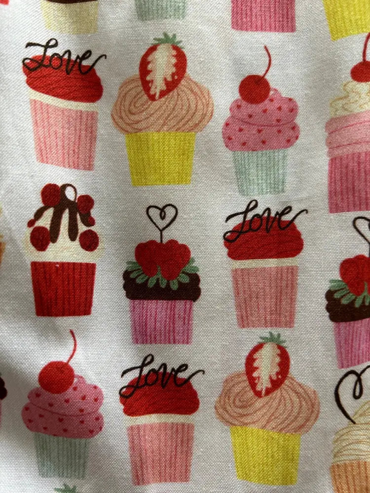Retro cupcake print sleeveless white cotton dress with colorful cupcake pattern and pockets featuring love script