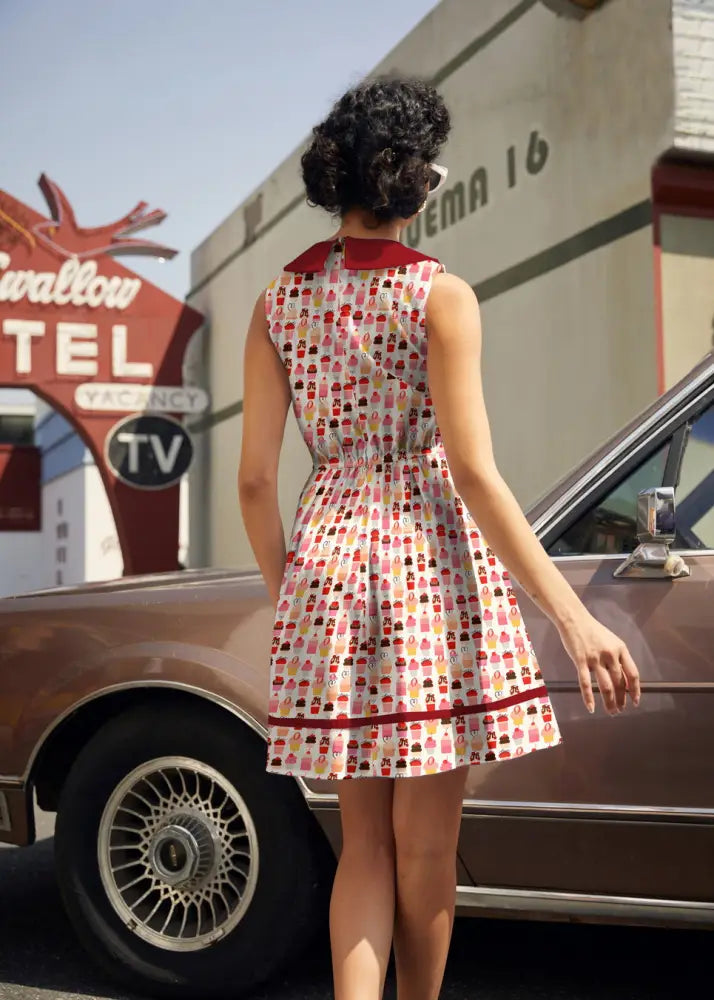 Retro cupcake print sleeveless cotton dress with pockets features a white base and colorful cupcake pattern with red trim