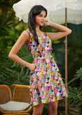 A vibrant sleeveless a-line skater dress with colorful cupcake print and pockets perfect for casual wear