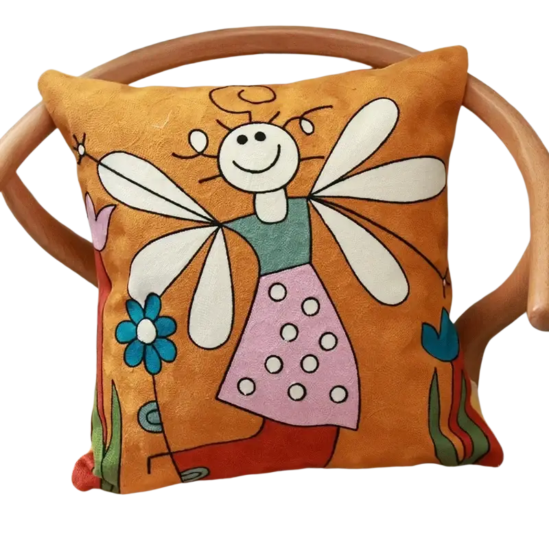 Orange plush cushion cover 45x45cm embroidered with a cartoon fairy in green and pink attire and white wings