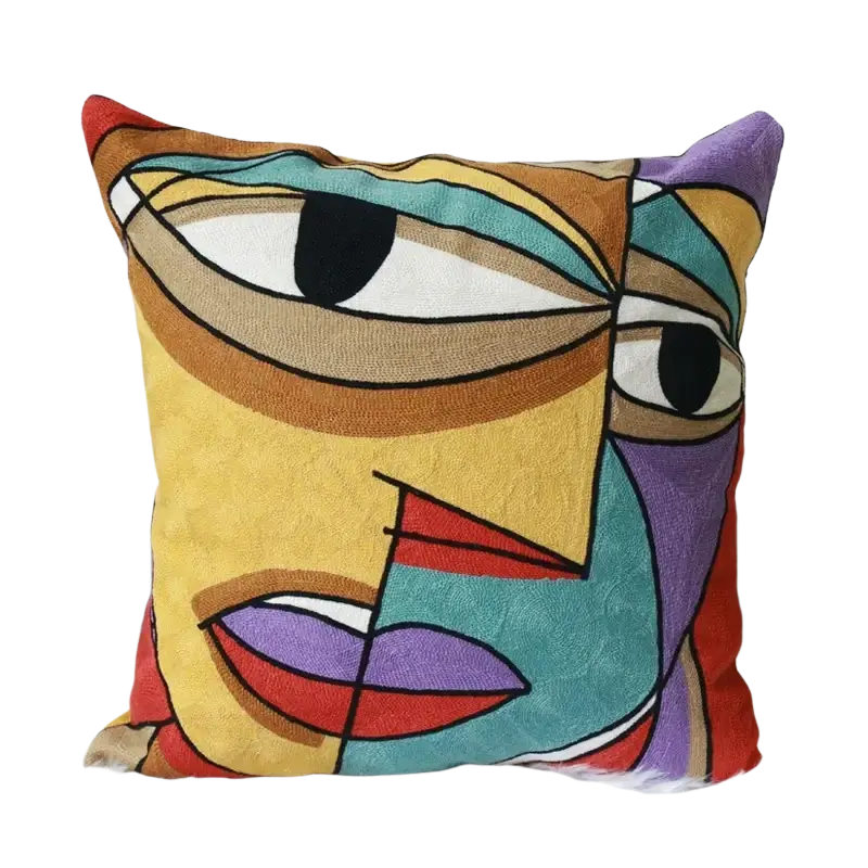 Vibrant embroidered cushion cover 45x45cm featuring a stylized abstract face with bold geometric shapes and vivid colors