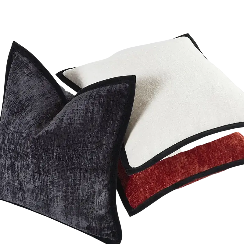 Two modern cushion covers in solid color chenille featuring charcoal velvet with black border and cream with red stripe pillow cover