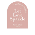 A soft pink arched wedding sticker with white let love sparkle text and personalized names and date for guests