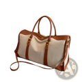 Custom canvas travel duffel bag with beige and brown leather trim and woven canvas body for durable travel use