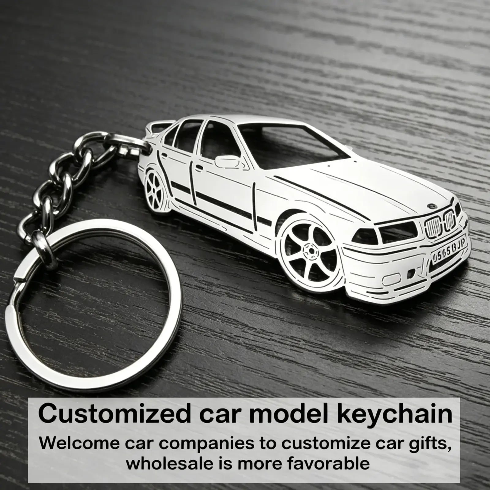 Silver metallic custom car model keychain shaped like a BMW e36 sedan with black detailing and chrome chain