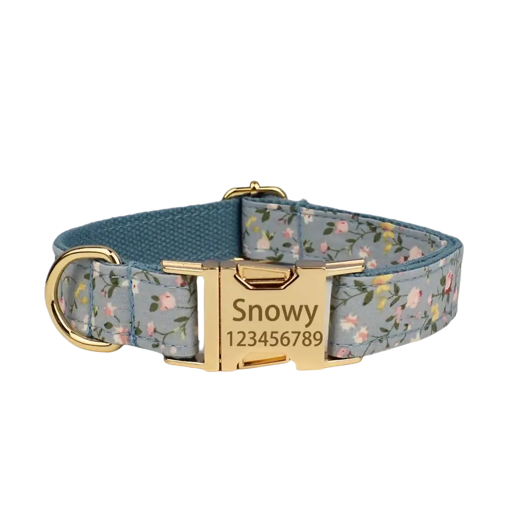 A light blue designer personalized dog collar with floral pattern gold hardware and engraved nameplate snowy 123456789