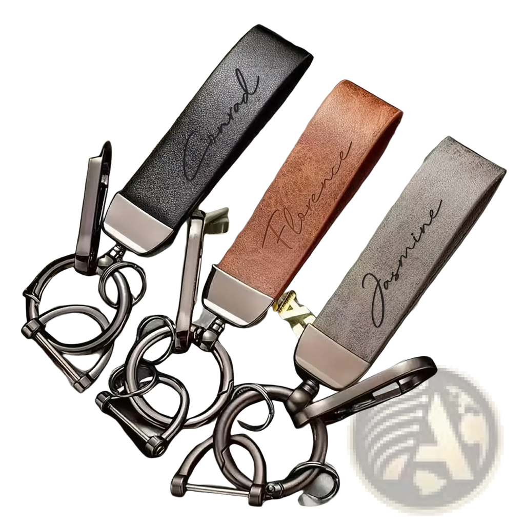 Three personalized brown leather keychains with custom engraved names and silver metallic hardware for gifts