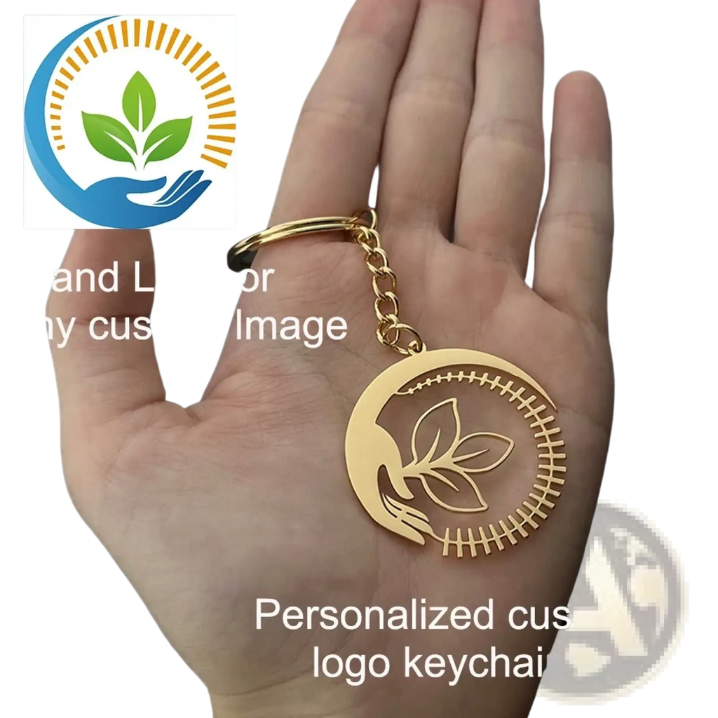 Gold-colored metal keychain with circular design engraved leaf motif and stitched border for personalized gifts