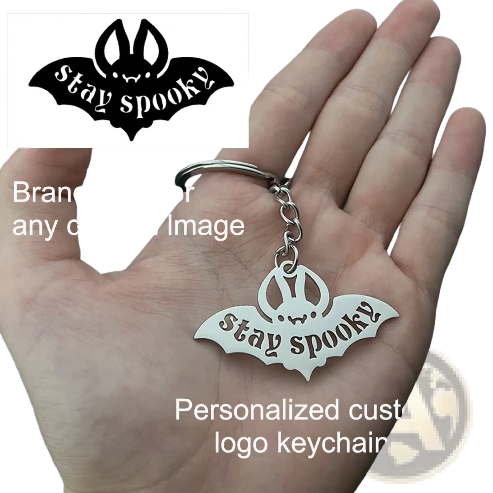 Silver metal bat-shaped keychain with stay spooky engraving and small bunny face for personalized gifts