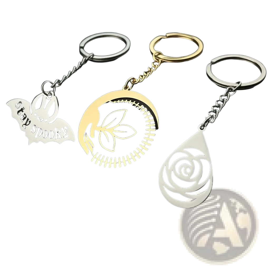 Custom engraved metal keychains in silver, gold, and white featuring personalized bat, leaf, and rose designs