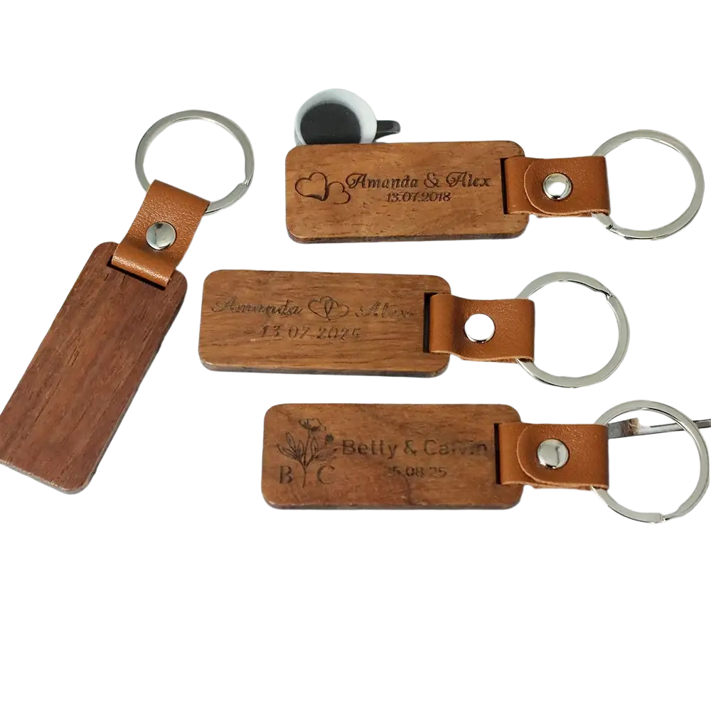 Custom engraved wooden leather keychains with tan straps and silver rings personalized with names and dates
