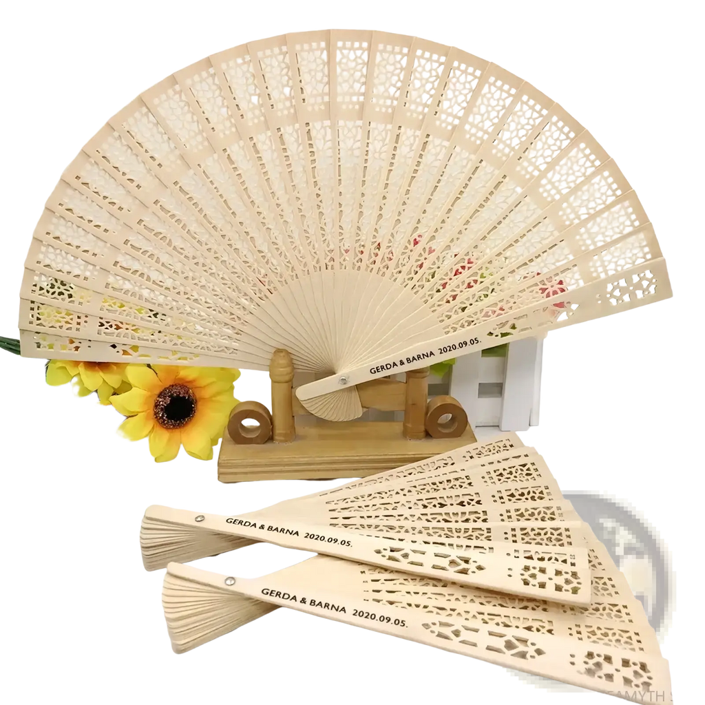 Beige wooden folding fan with intricate lace-like cutouts and custom engraved text for wedding fan favors