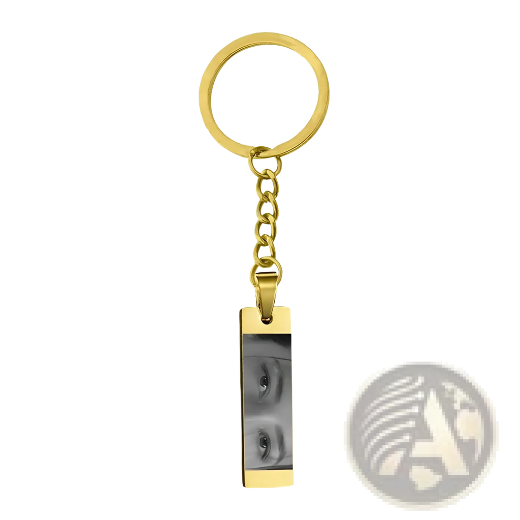 Gold-colored stainless steel rectangular keychain engraved with custom black and white eye photograph