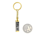 Gold-colored stainless steel rectangular keychain engraved with custom black and white eye photograph