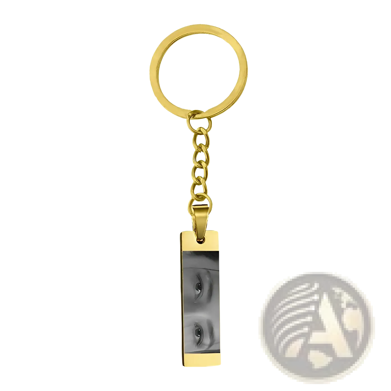 Gold-colored stainless steel rectangular keychain engraved with custom black and white eye photograph