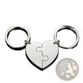 Silver custom family puzzle heart keychain with two interlocking puzzle-piece halves attached to circular rings