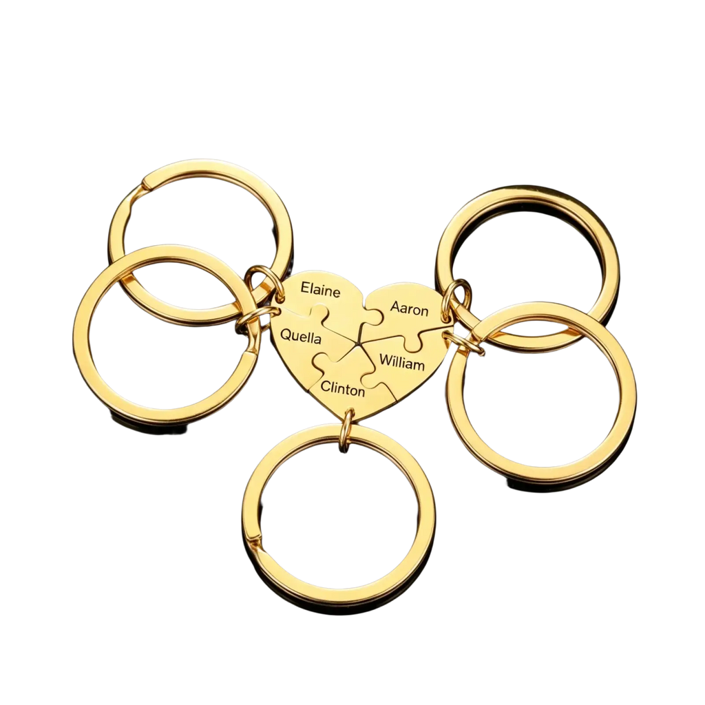 Custom family puzzle heart keychain in gold color featuring engraved names elaine aaron quella william and clinton