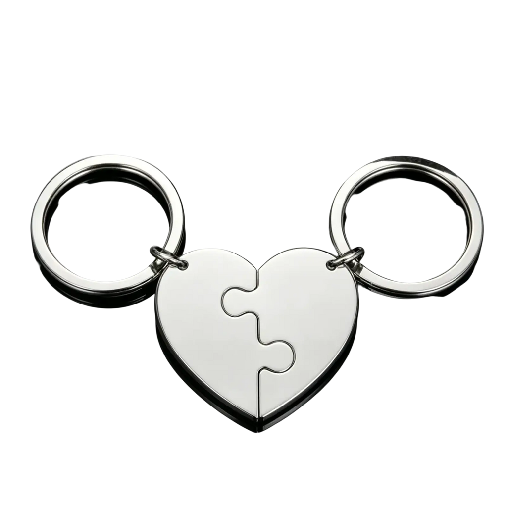 Silver custom family puzzle heart keychain with two interlocking puzzle-piece halves attached to circular rings