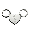 Silver custom family puzzle heart keychain with two interlocking puzzle-piece halves attached to circular rings