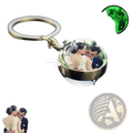 A luminous-style custom glow photo keychain with a clear round glass globe featuring a couple kissing inside