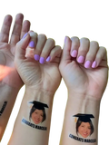 Custom graduation face tattoo featuring a smiling woman in a cap with congrats marcela printed below for party favors