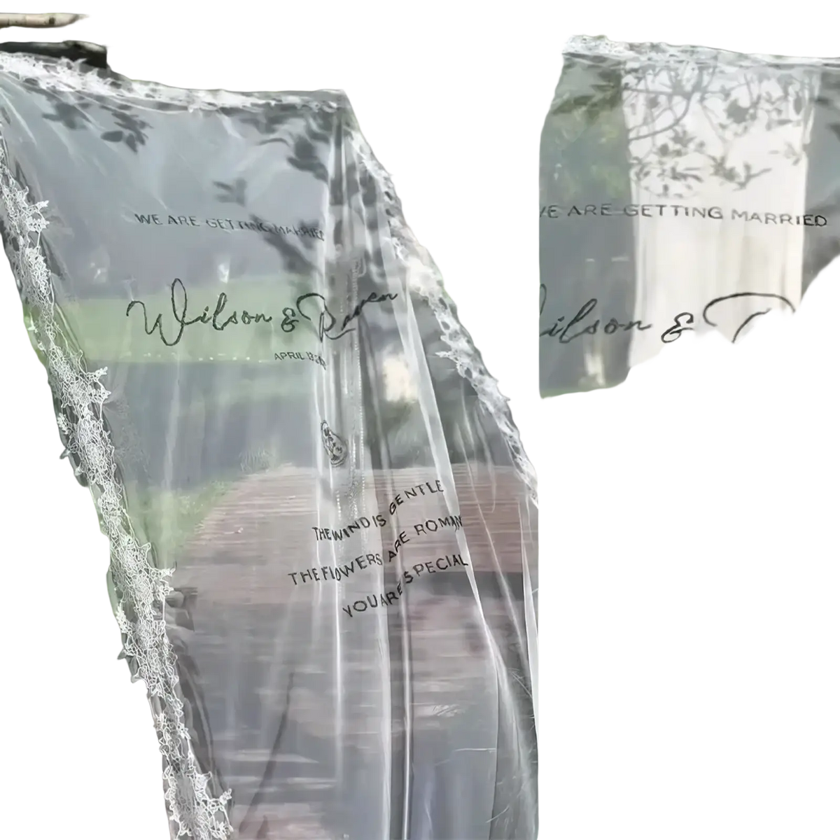 Custom lace wedding welcome sign banner clear sheer curtain with delicate lace trim and black cursive text hanging outdoors