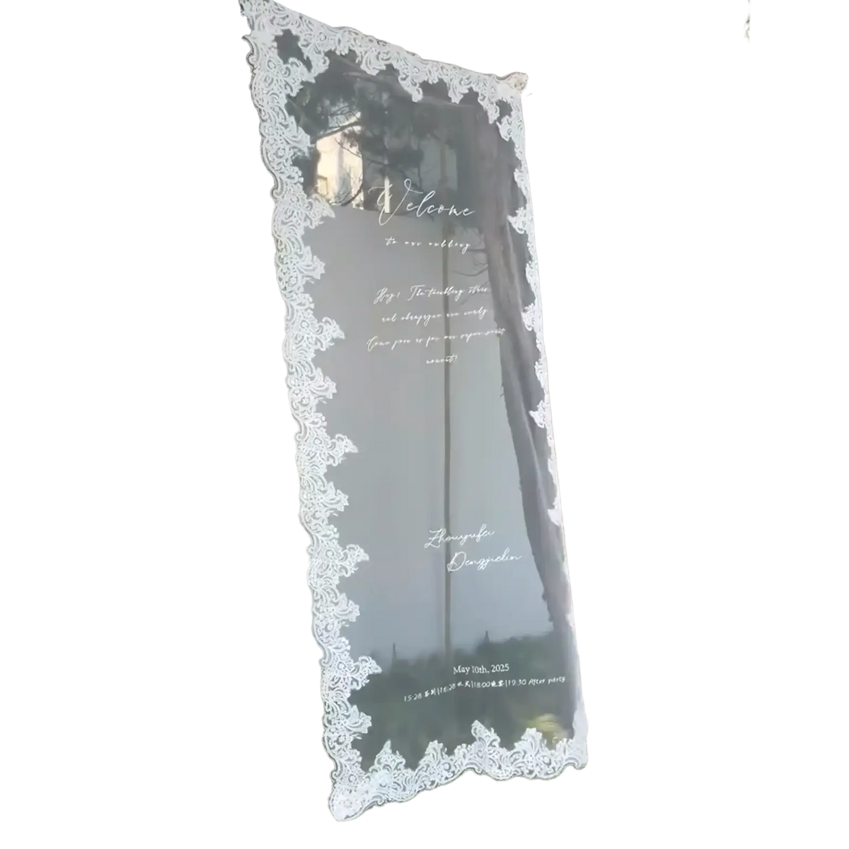 A translucent custom lace wedding welcome sign banner with intricate white lace trim and elegant cursive text