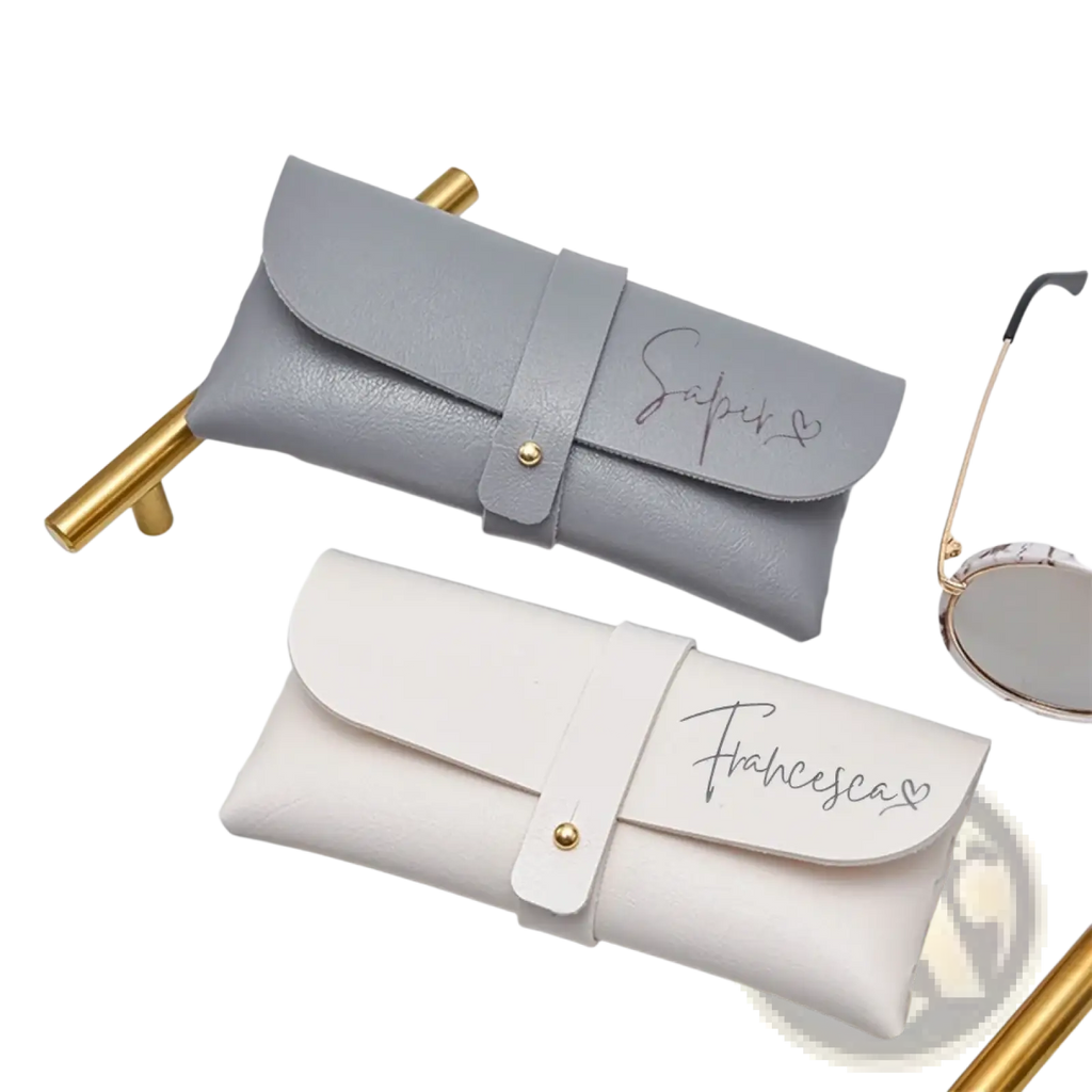 Custom leather glasses cases in gray and white leather with gold-tone hardware and personalized name engraving