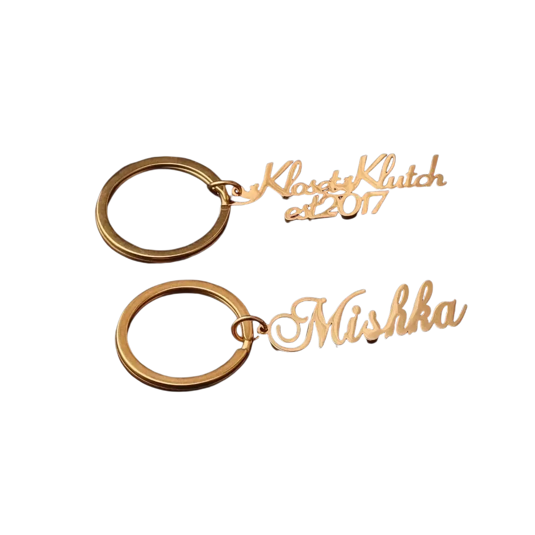 Gold-colored stainless steel custom name keychains engraved with kloset klutch est 2017 and mishka names gift