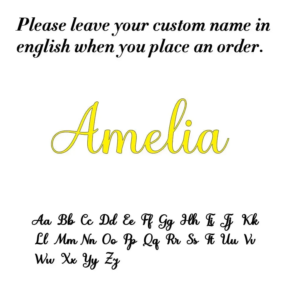 Custom stainless steel name keychain with yellow cursive amelia nameplate and black outline displayed above alphabet chart