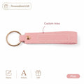 Custom name pink leather keychain featuring a pink leather key fob with a gold-toned metal ring and button