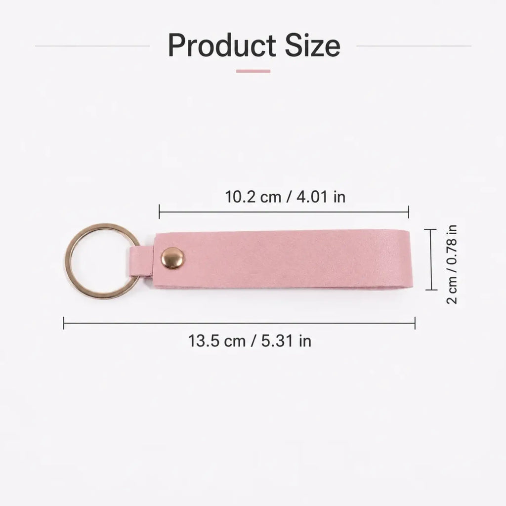 A sleek pale pink leather custom name keychain with a gold-toned metal ring and button closure
