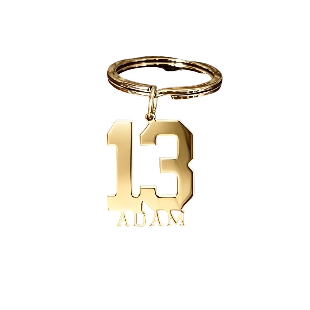 Gold-colored metal custom number and name keychain engraved with number 13 and name adam for personalized use