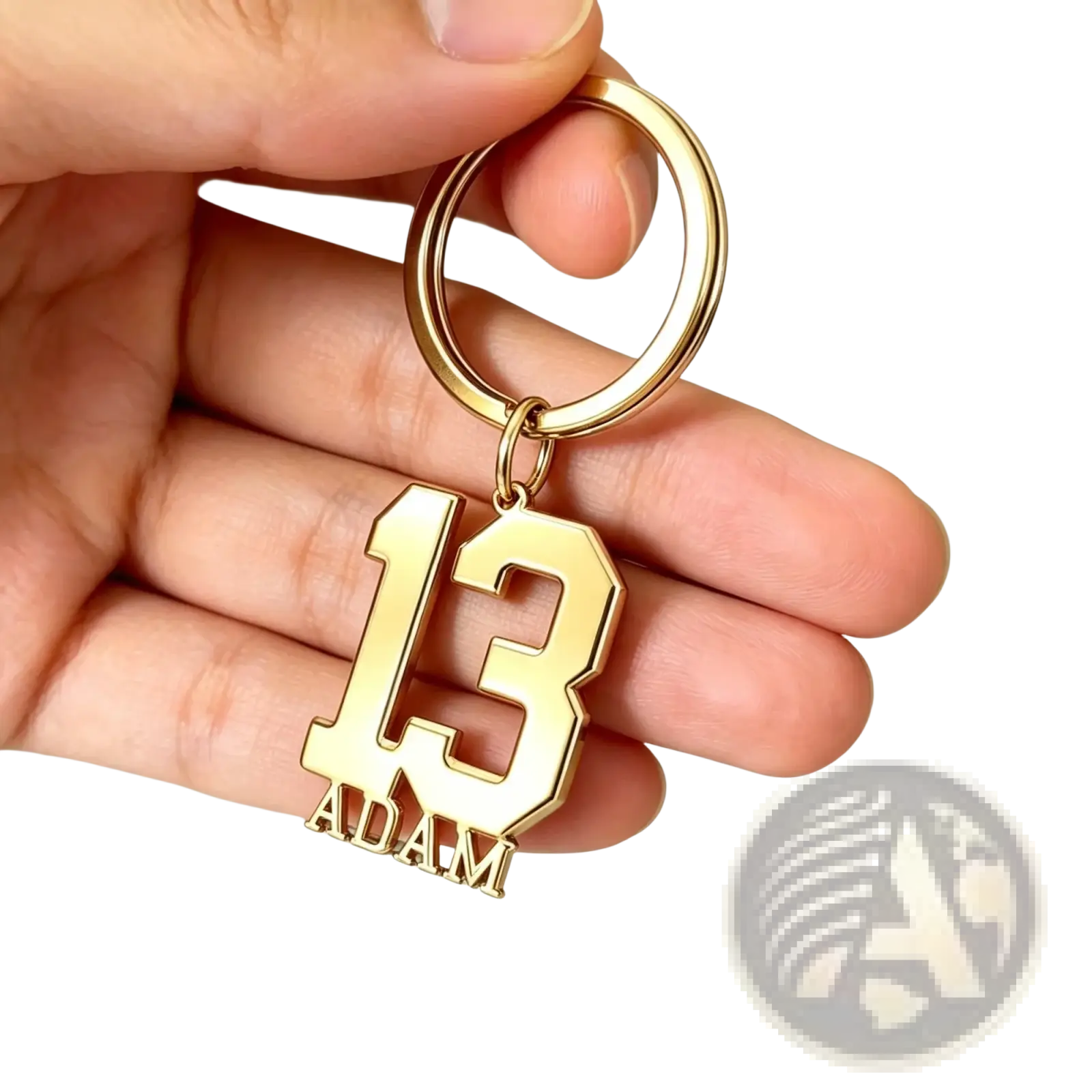 Gold-colored metal custom number and name keychain with bold cut-out 13 and name adam in matching lettering