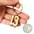 Custom number and name keychain in gold color with number 13 and name Adam engraved in bold blocky font