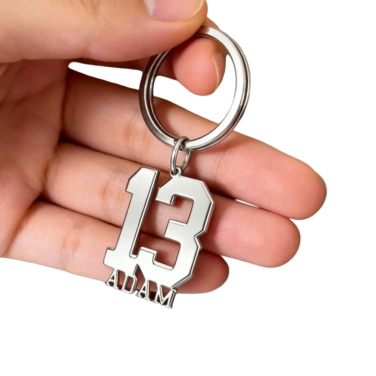 Silver metallic custom number and name keychain with bold cut-out 13 and adam engraved below in athletic font