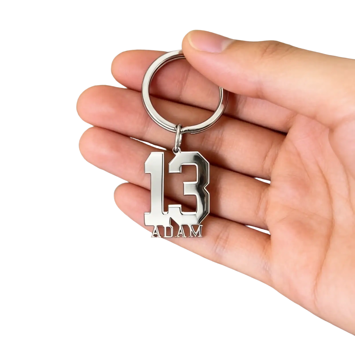 Silver metallic custom number and name keychain with bold 13 and adam in classic sports jersey font