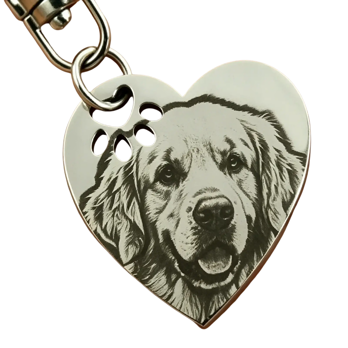 A stainless steel heart keychain with engraved golden retriever portrait and three paw print cutouts on top edge