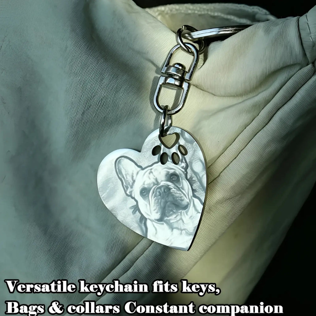 Silver stainless steel heart keychain featuring an engraved french bulldog portrait with paw print cutouts